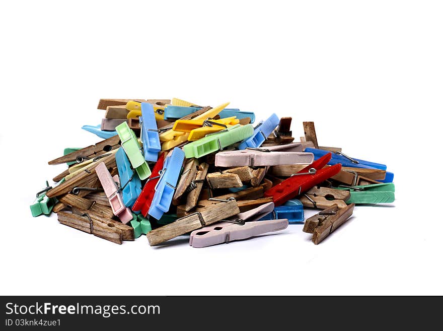 Close up view of some colorful cloth pegs isolated on a white background.