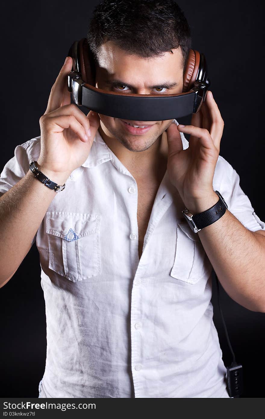 Image of young sly man with headphones. Image of young sly man with headphones