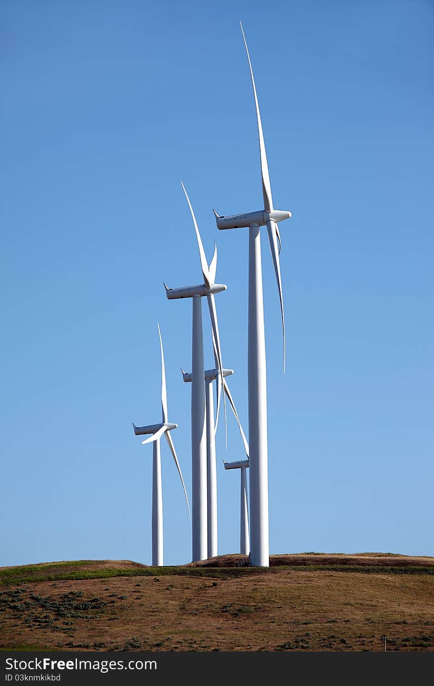 Wind turbines on top of a hill in Washington state. Wind turbines on top of a hill in Washington state.