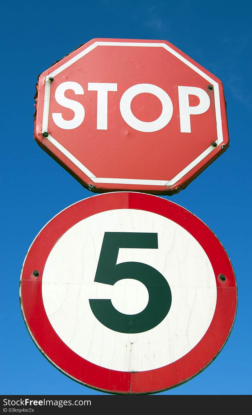 The old road sign on the background of blue sky