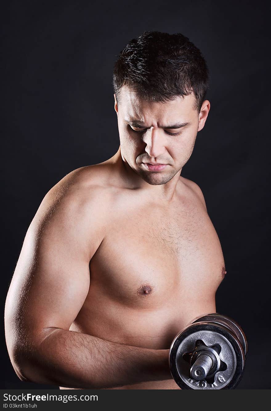 Athlete is lifting dumbbells