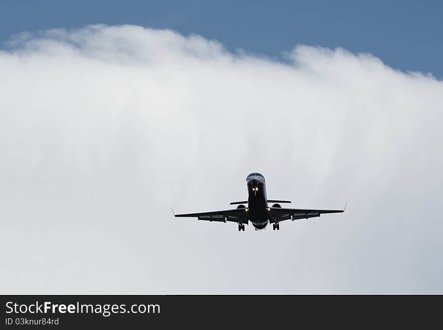 Airplane is landing from clouds.