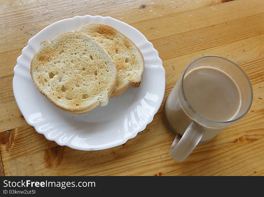 Coffee With Milk And Bread Slices.