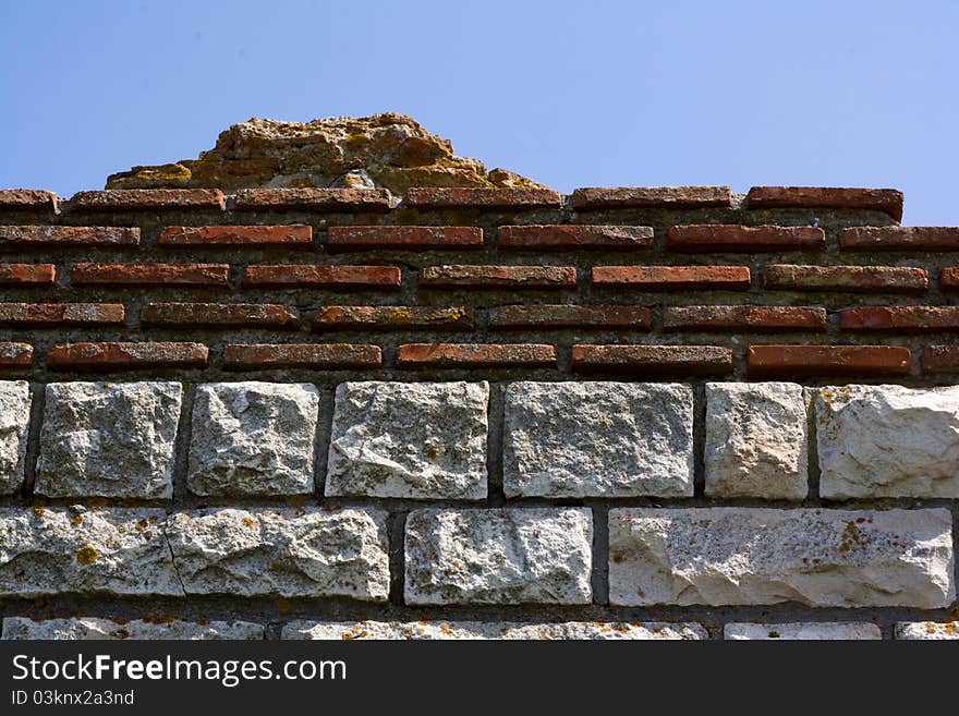 Unfinished old building. Historical ruins against a blue sky