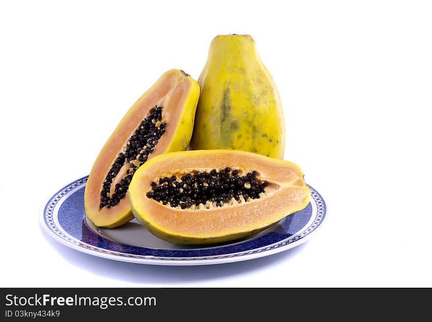 Close up view of papaya fruit sliced presented on a dish.