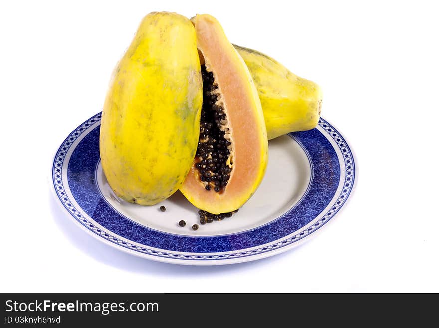 Close up view of papaya fruit sliced presented on a dish.