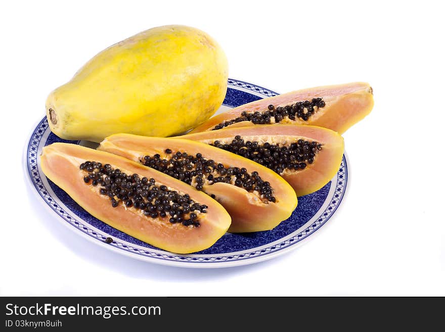 Close up view of papaya fruit sliced presented on a dish.