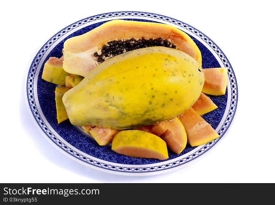 Close up view of papaya fruit sliced presented on a dish.