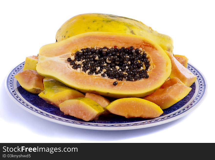 Close up view of papaya fruit sliced presented on a dish.