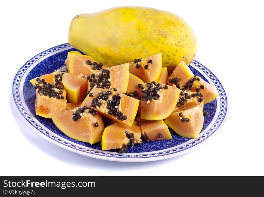 Close up view of papaya fruit sliced presented on a dish.