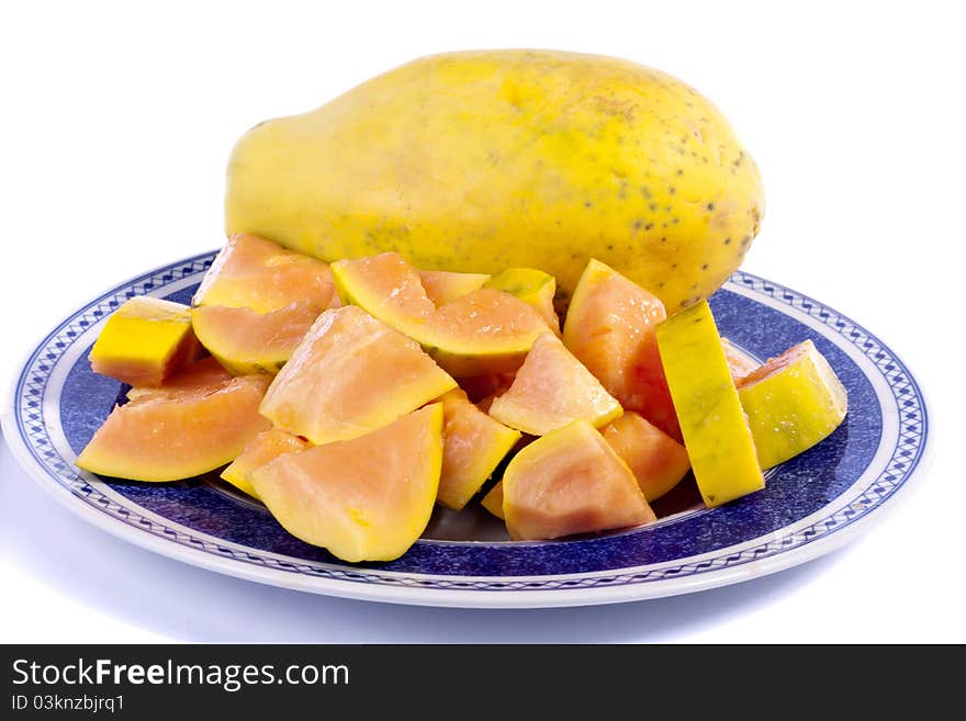 Close up view of papaya fruit sliced presented on a dish.