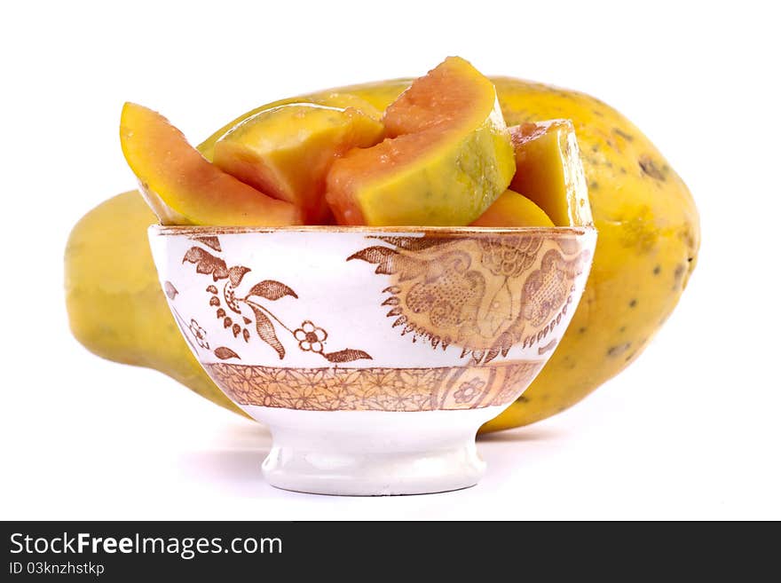 Close up view of papaya fruit sliced presented on a bowl.