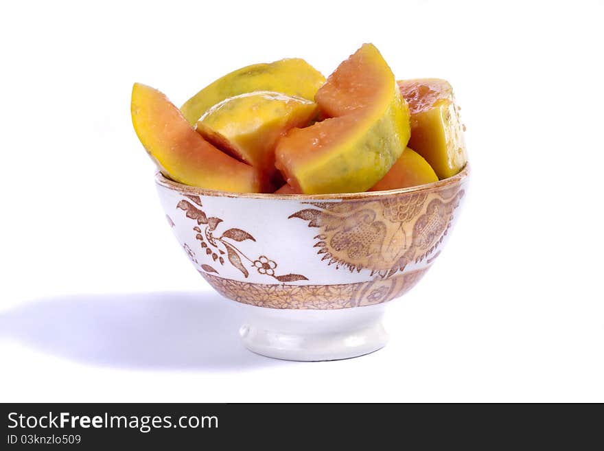 Close up view of papaya fruit sliced presented on a bowl.