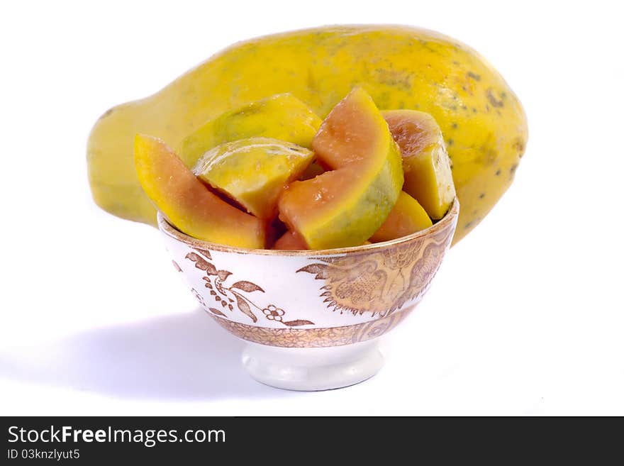 Close up view of papaya fruit sliced presented on a bowl.