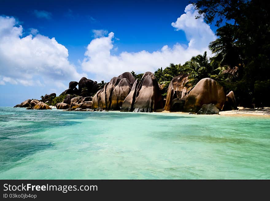 Detail of a granite stone on a beach of La Digue Island at the Seychelles island. The beach is in the famous Anse source dargent park. Detail of a granite stone on a beach of La Digue Island at the Seychelles island. The beach is in the famous Anse source dargent park.