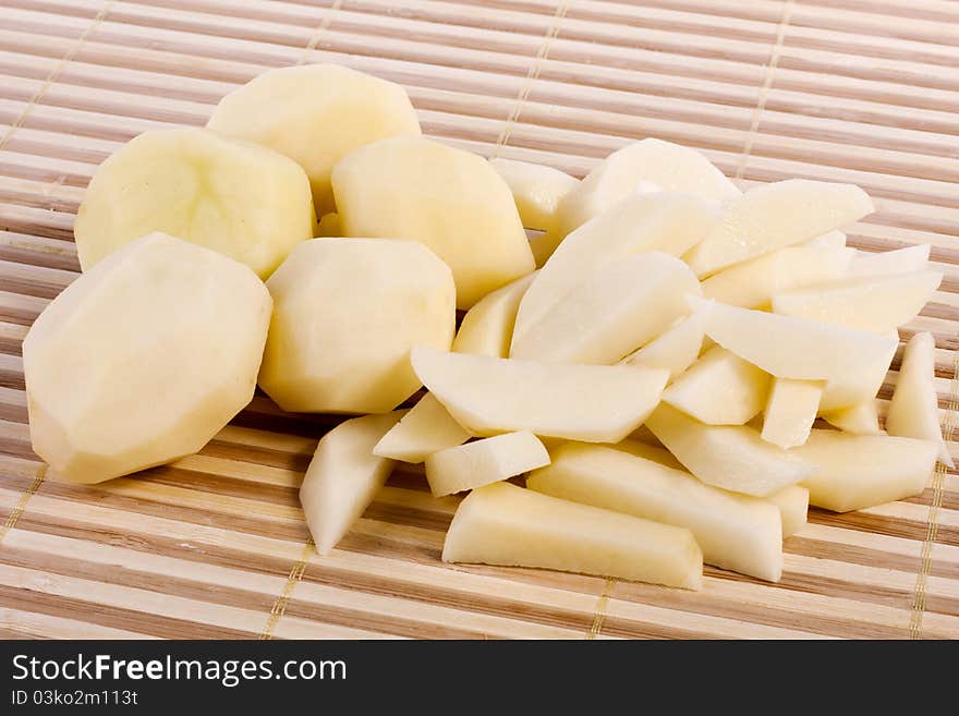 Close up view of some sliced potatoes  on bamboo background.