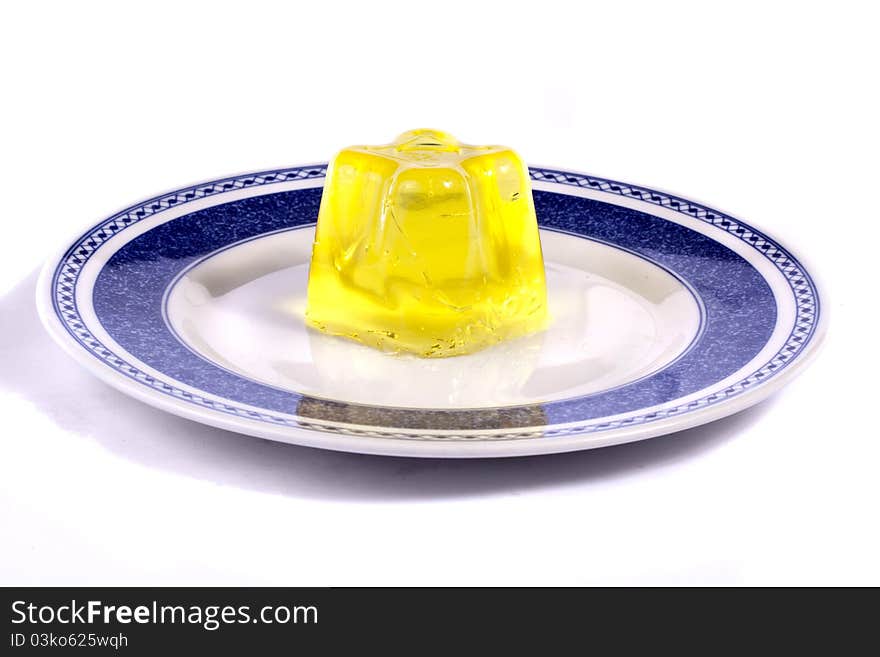 Close up view of a yellow gelatin isolated on a white background.