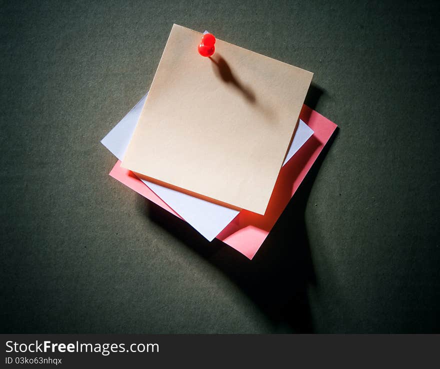 Image of note pad reminders on dark cardboard wall. Image of note pad reminders on dark cardboard wall