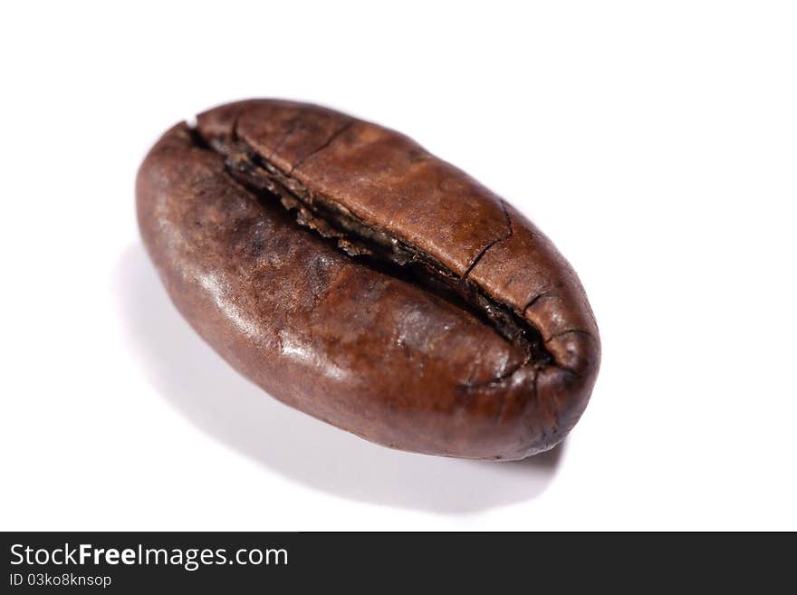 Close up view of a single roasted bean of coffee.