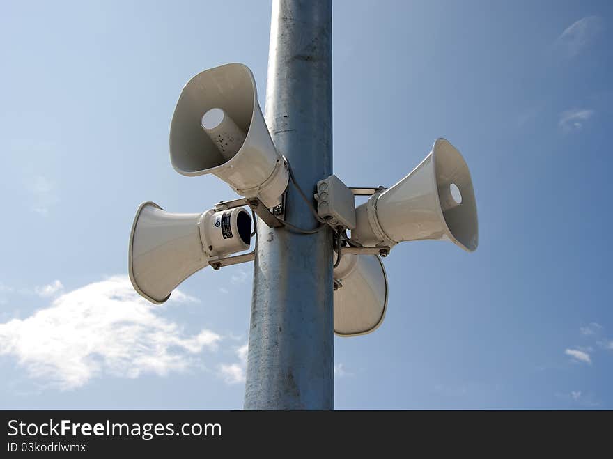 Four megaphone hanging on a pole