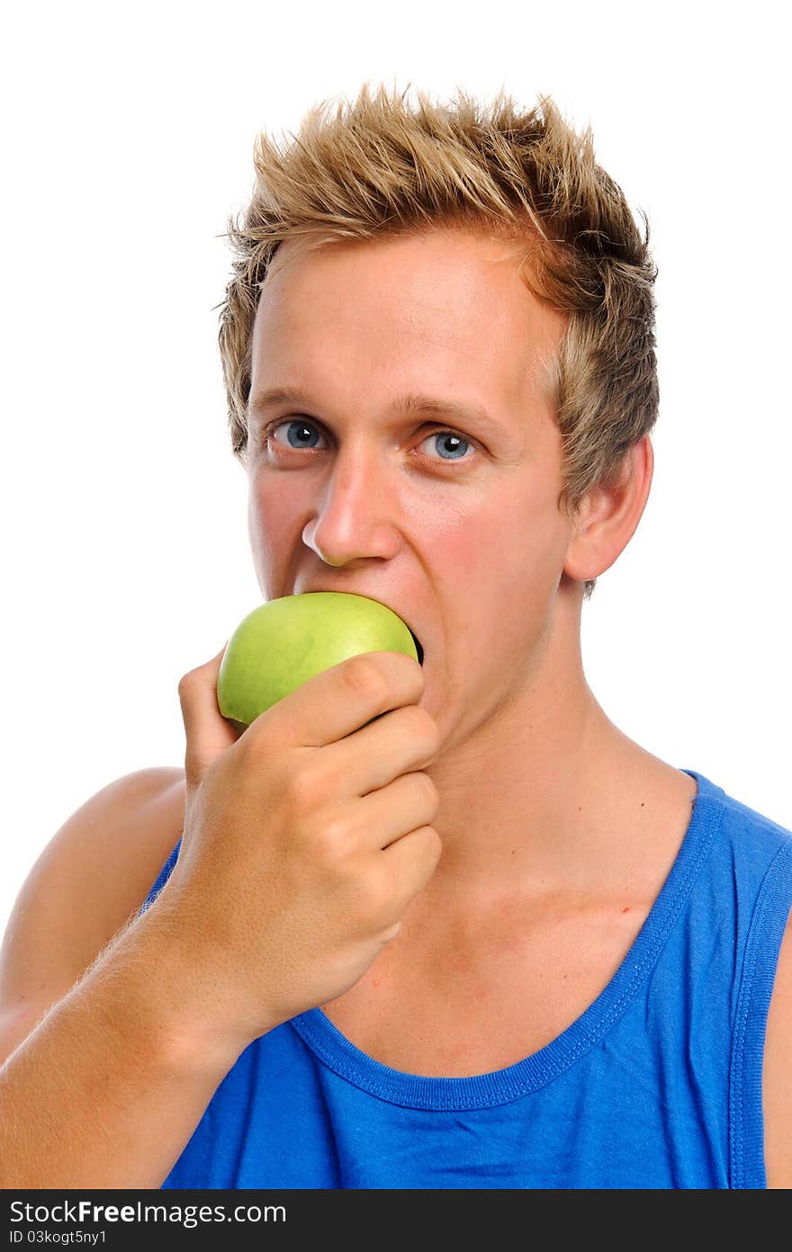 Handsome caucasian man biting into a green apple isolated on white. Handsome caucasian man biting into a green apple isolated on white