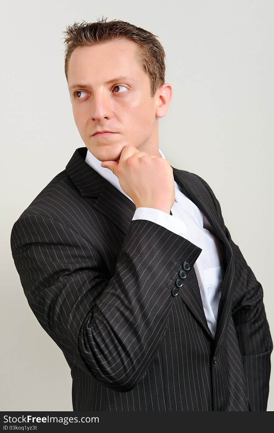 Attractive white executive is thinking in a smart suit. Attractive white executive is thinking in a smart suit