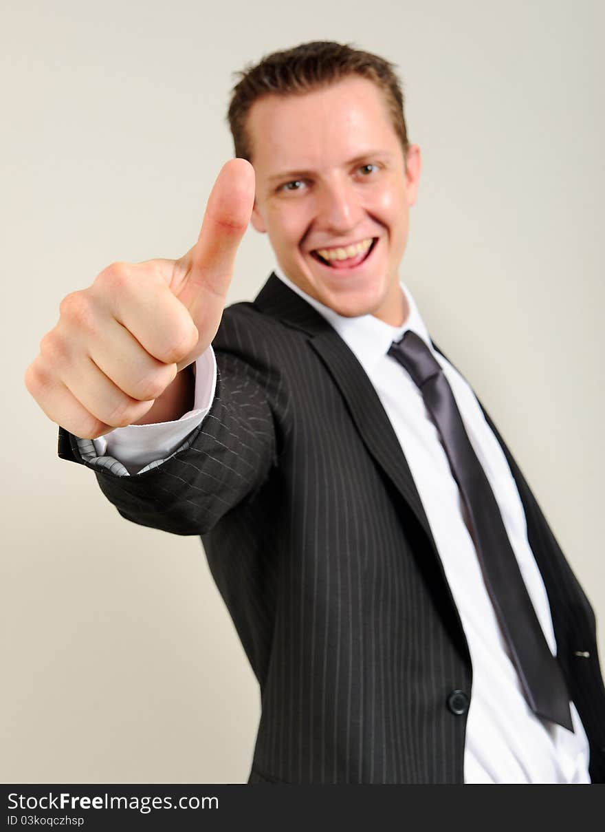 Cheerful and confident caucasian executive gives a thumbs up sign. Cheerful and confident caucasian executive gives a thumbs up sign