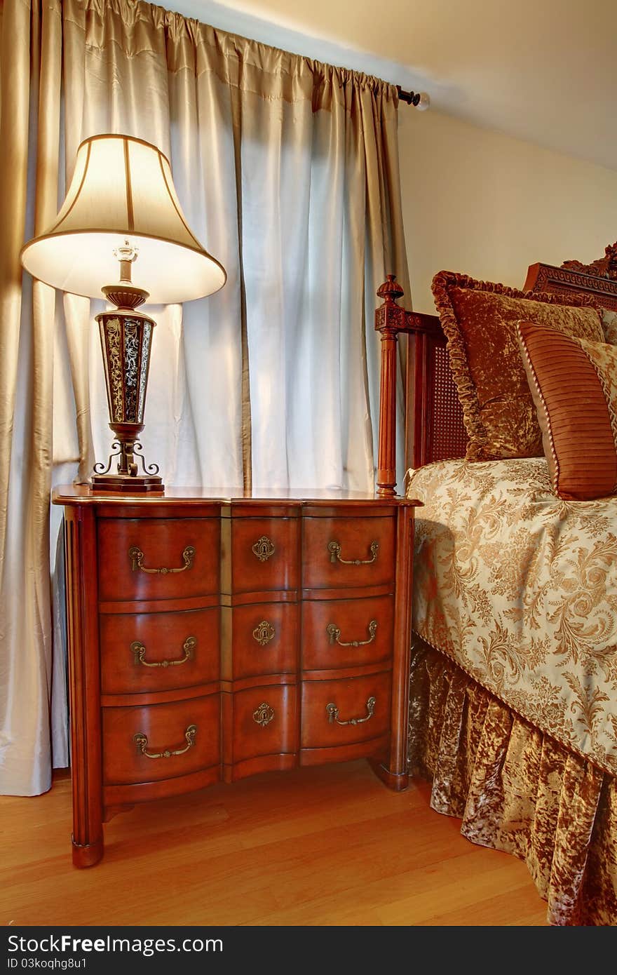 Classic brown nightstand near the bed. Classic brown nightstand near the bed