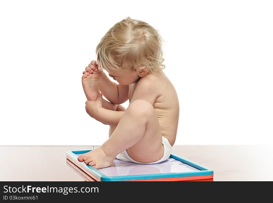 Two years old boy with draw desk on the table. Two years old boy with draw desk on the table