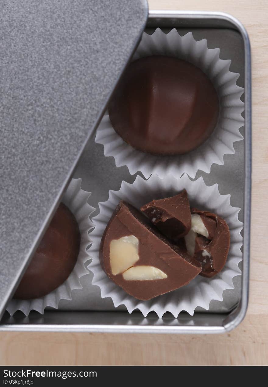 Chocolate nut truffles in silver metal box. Chocolate nut truffles in silver metal box