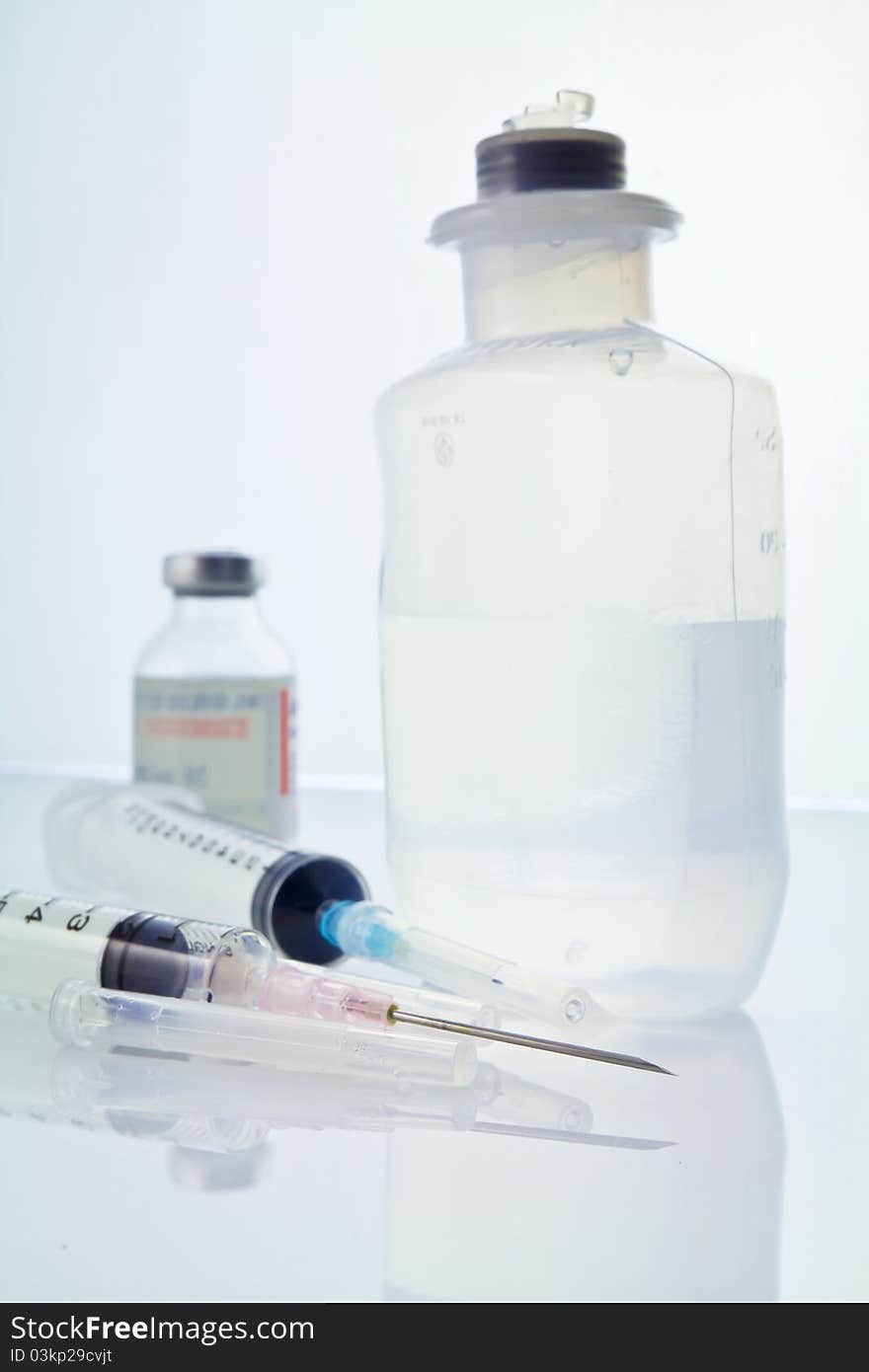 Syringe and saline solution on the lab's table. Syringe and saline solution on the lab's table