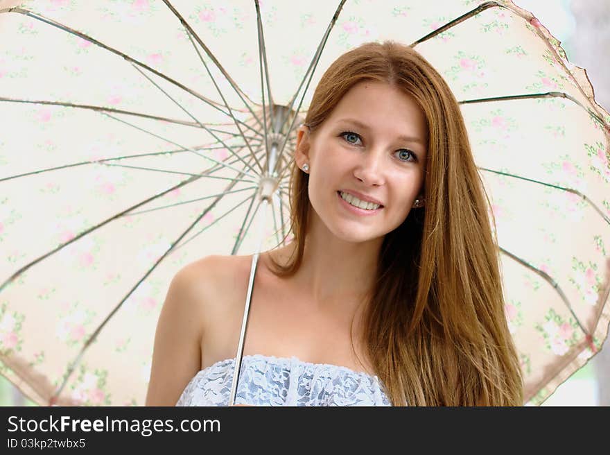 Portrait of a beautiful girl at the park with umbrella. Portrait of a beautiful girl at the park with umbrella