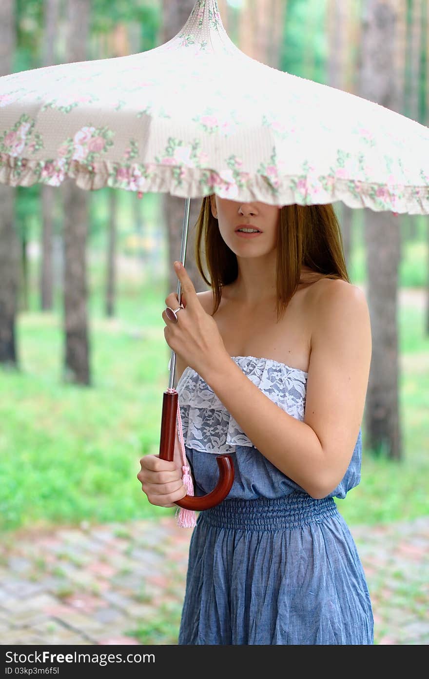 Portrait of a beautiful girl at the park with umbrella. Portrait of a beautiful girl at the park with umbrella