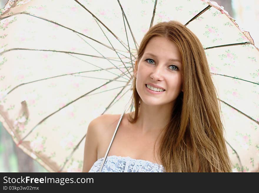 Portrait of a beautiful girl at the park with umbrella. Portrait of a beautiful girl at the park with umbrella