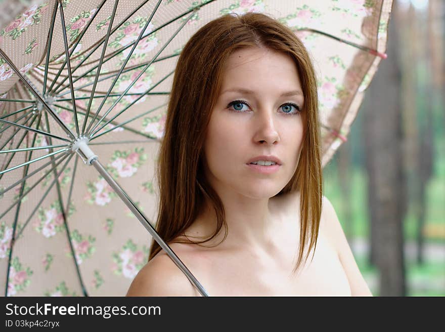 Portrait of a beautiful girl at the park with umbrella. Portrait of a beautiful girl at the park with umbrella