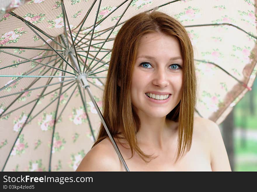 Portrait of a beautiful girl at the park with umbrella. Portrait of a beautiful girl at the park with umbrella