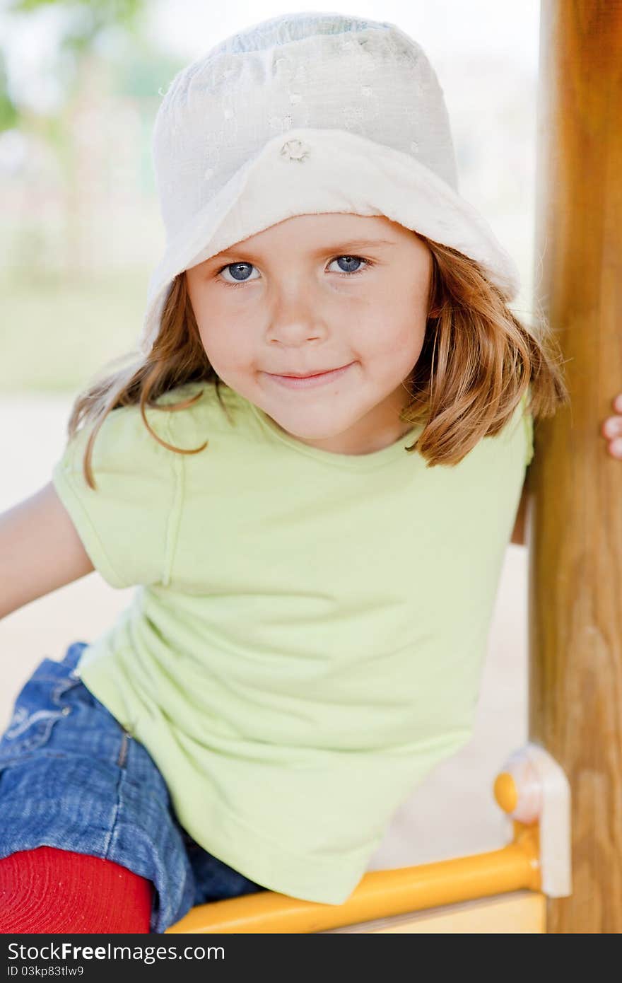 Small girl playing on children's playground