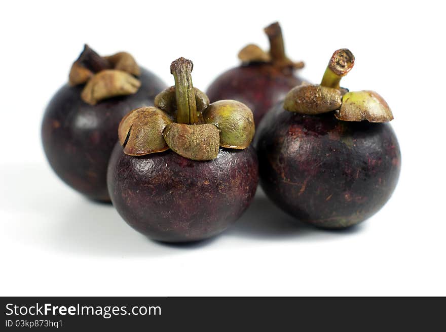 Mangosteens isolated on the white background.