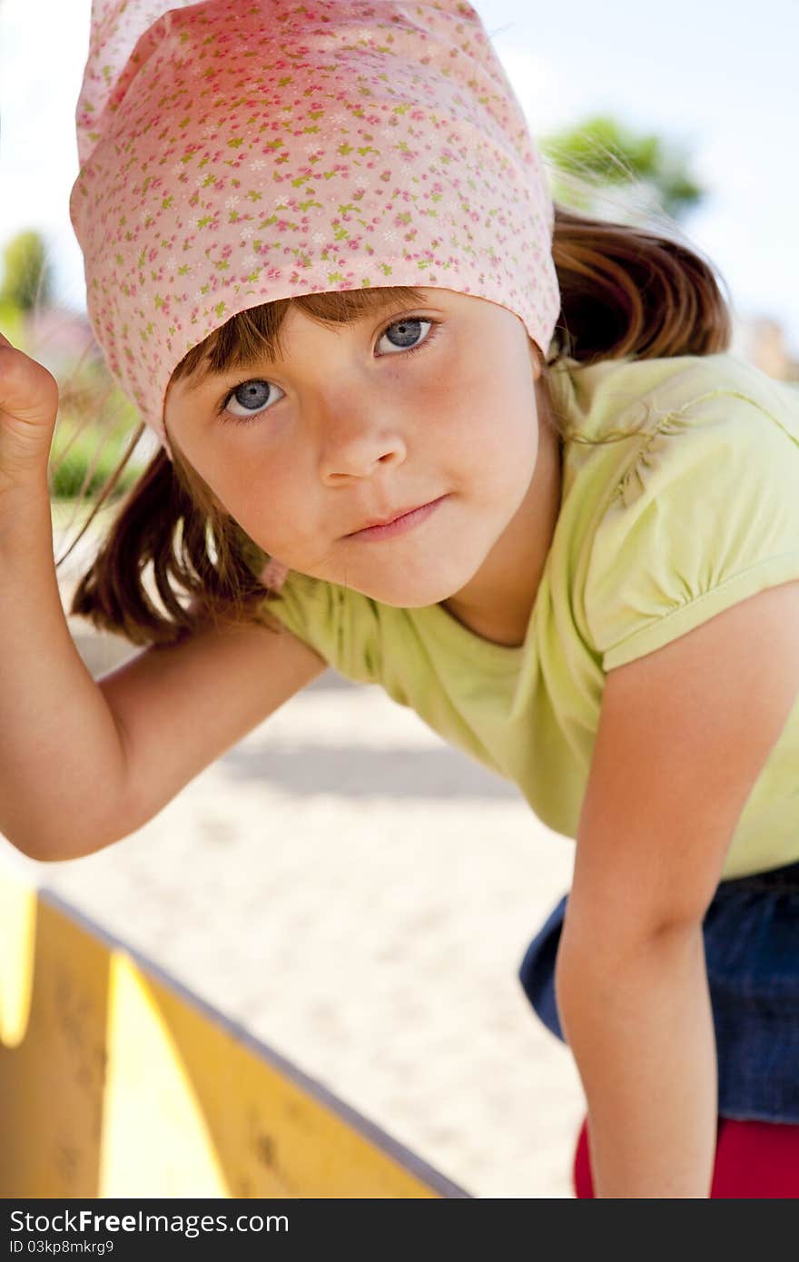 Small girl playing on children's playground