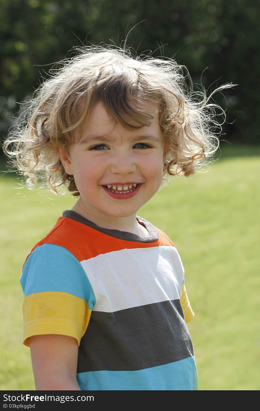 A young charming boy looks directly in the camera. A young charming boy looks directly in the camera.