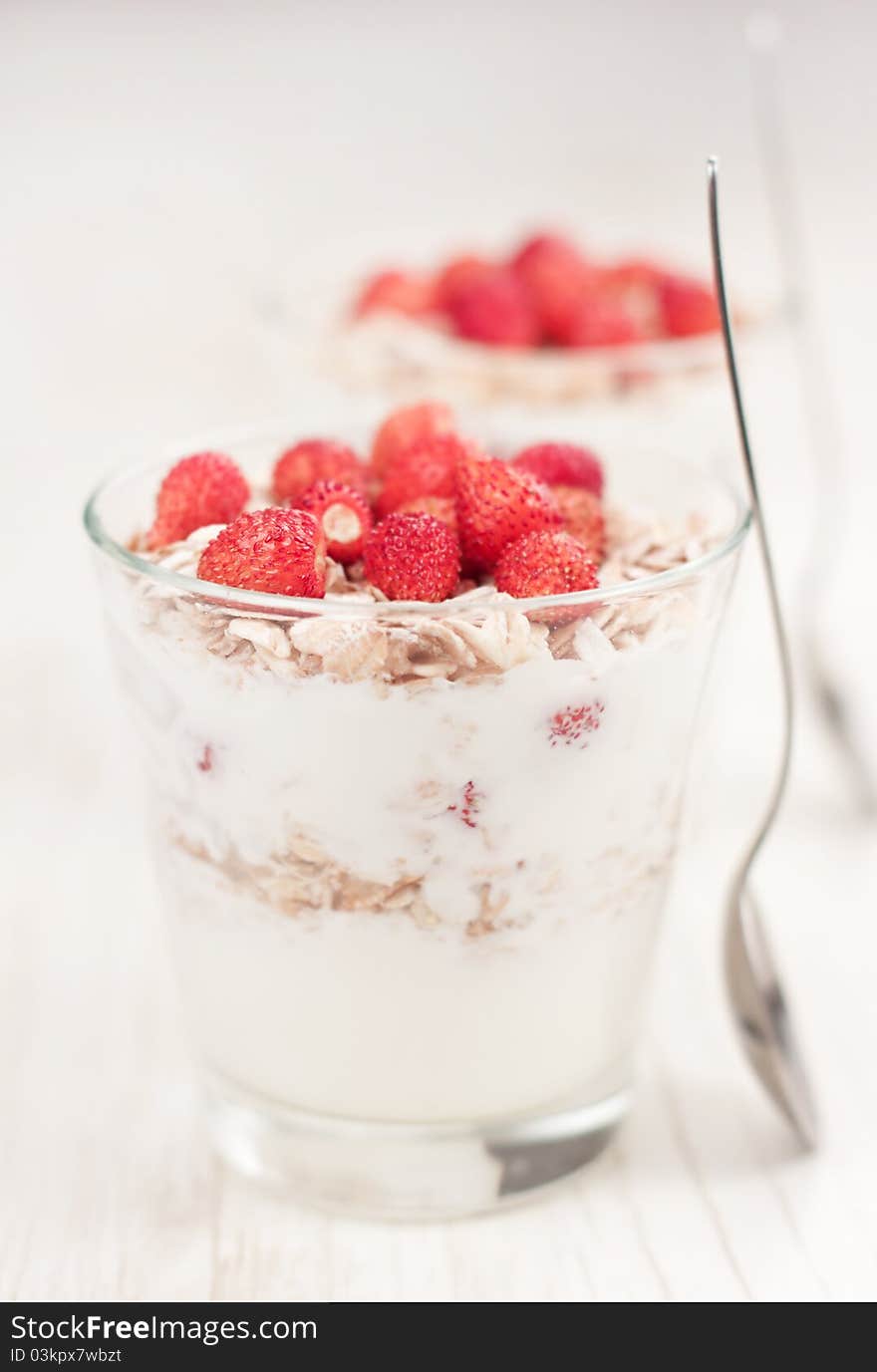 Natural yogurt with muesli and wild strawberries. Natural yogurt with muesli and wild strawberries