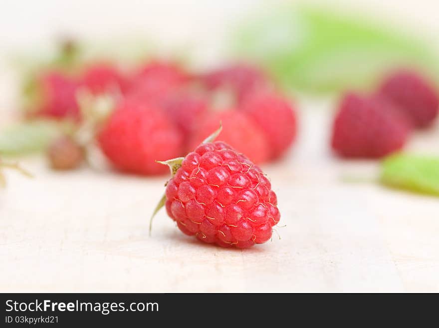 Raspberries on wooden backgroun d