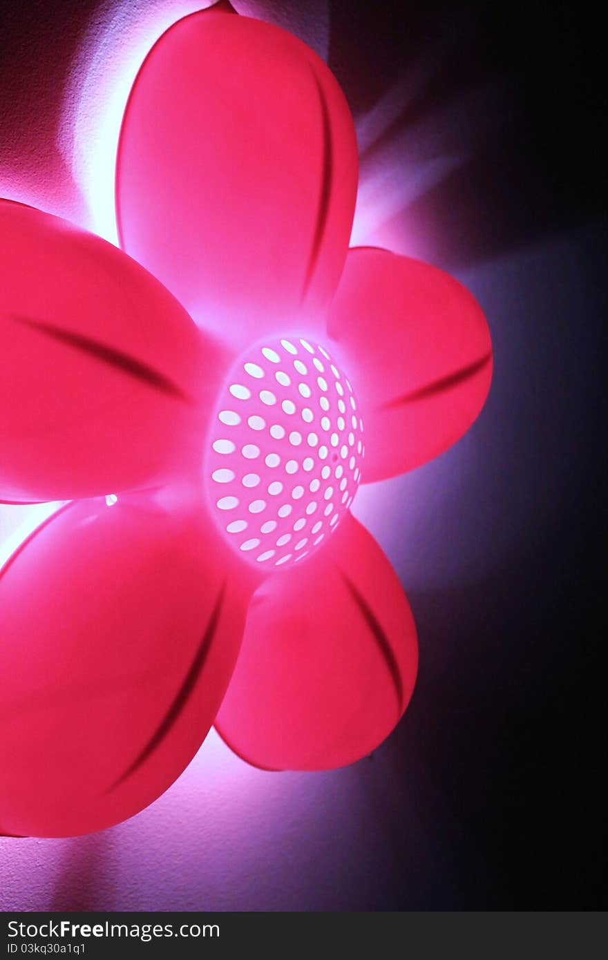 Funky and bright abstract pink flower light against black background. Funky and bright abstract pink flower light against black background.