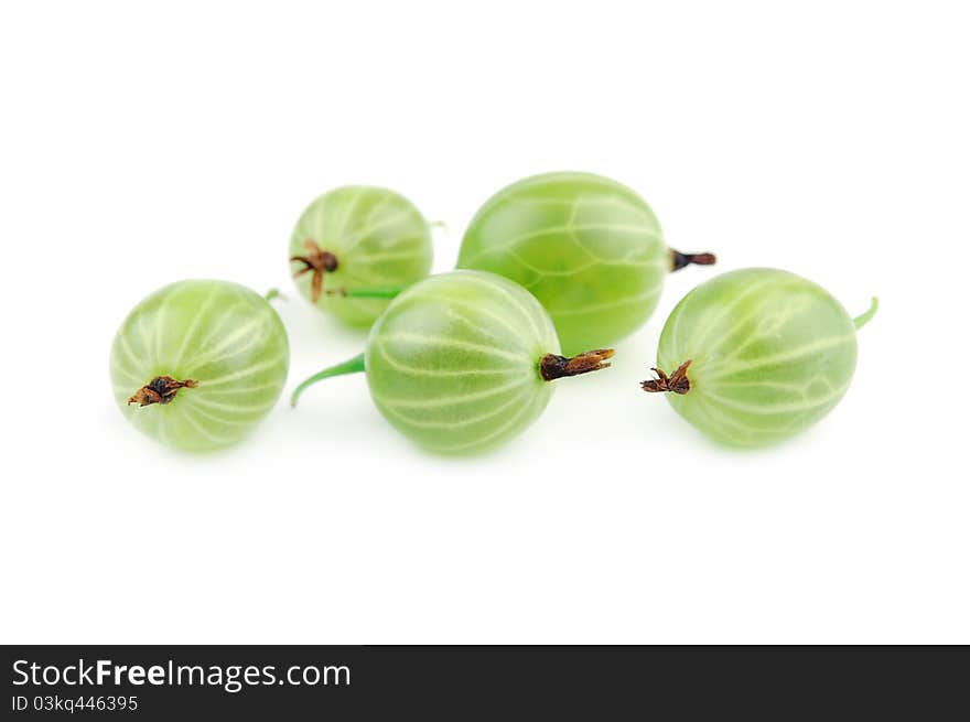 Green gooseberry fruit closeup on a white background. Selective focus. Green gooseberry fruit closeup on a white background. Selective focus.