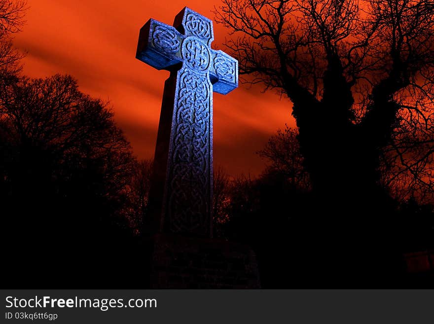 Night scenes cross light with a torch with silhouette trees and a red sky. Night scenes cross light with a torch with silhouette trees and a red sky