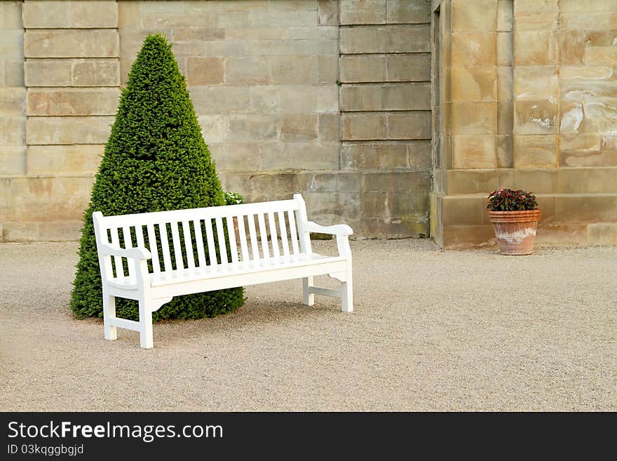 Empty white wooden bench in yard. Empty white wooden bench in yard