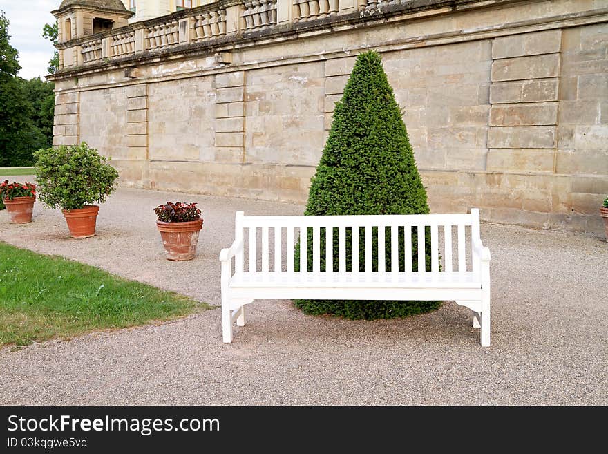 Empty white wooden bench in yard. Empty white wooden bench in yard