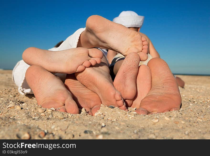 Family Lying On Sand