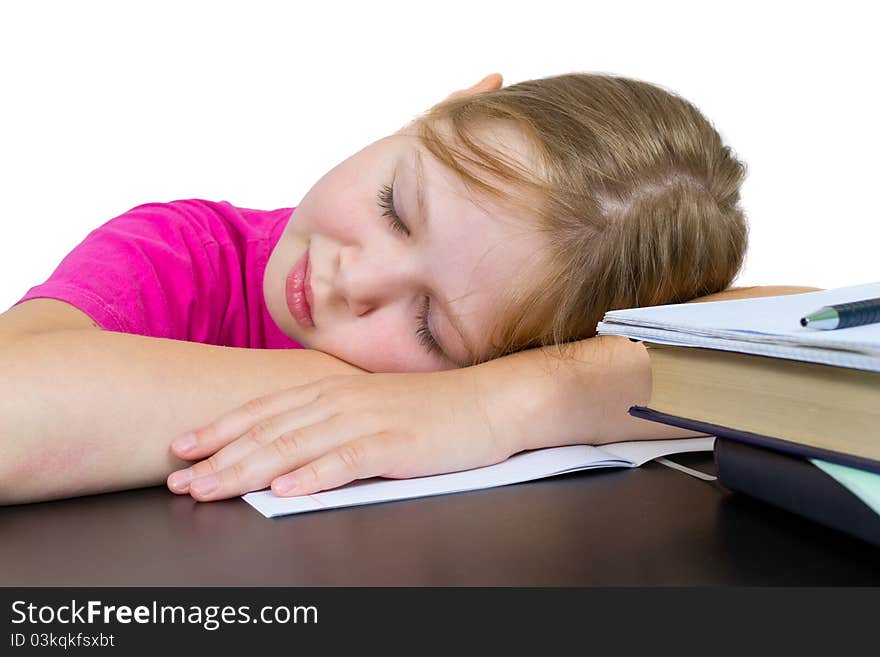 The girl has fallen asleep over textbooks