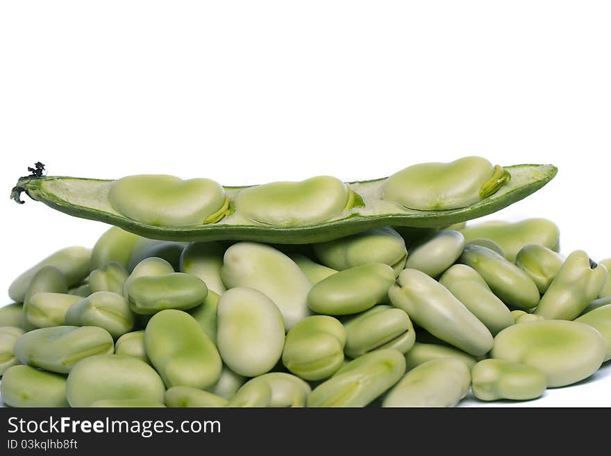 Close up view of some broad beans isolated on a white background.